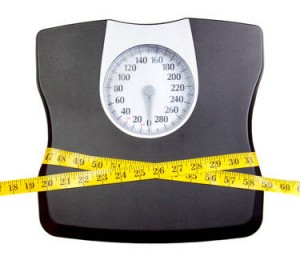 A bathroom scale with a measuring tape, weight loss concept
